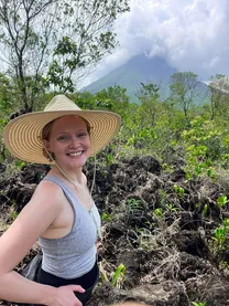Gracie Delaney in a sun hat on a mountain trail