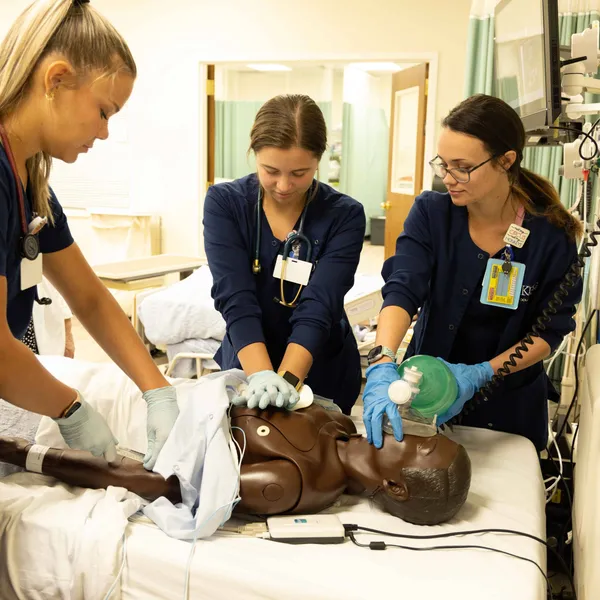 School of Nursing students practice chest compressions on one of the new high-fidelity nursing simulators installed in White Hall