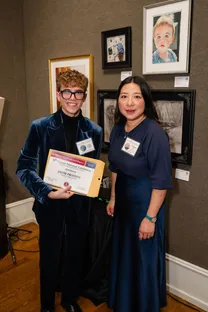 Jacob Proffitt holding his award certificate at the Grand National Exhibition